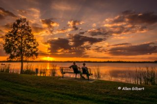2 people watching sunset on Lake Bess picture